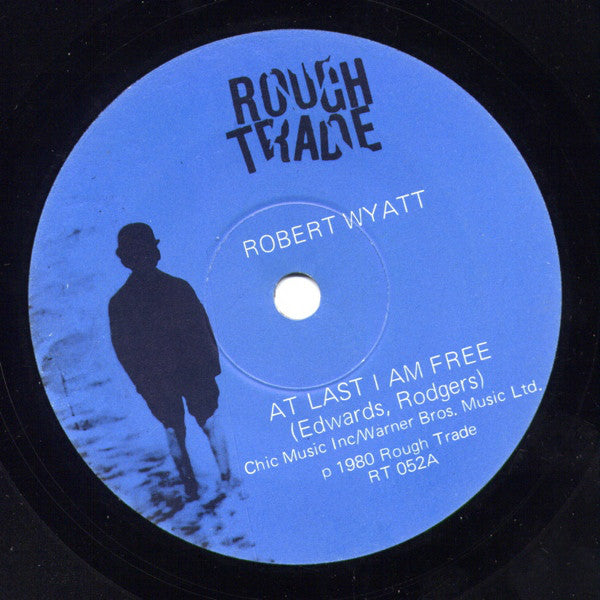 Robert Wyatt : At Last I Am Free / Strange Fruit (7", Single)