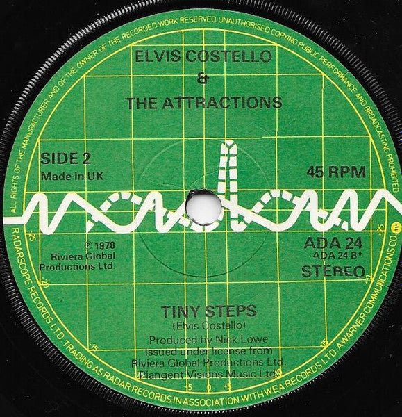 Elvis Costello And The Attractions* : Radio Radio (7", Single, Gre)